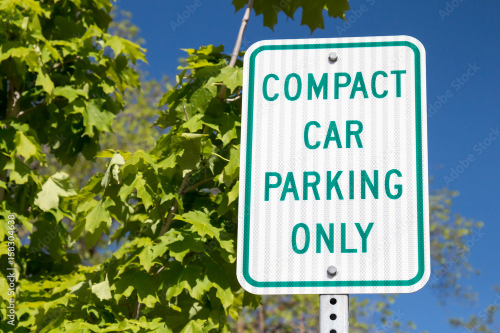 Compact car parking only sign with green oak leaves