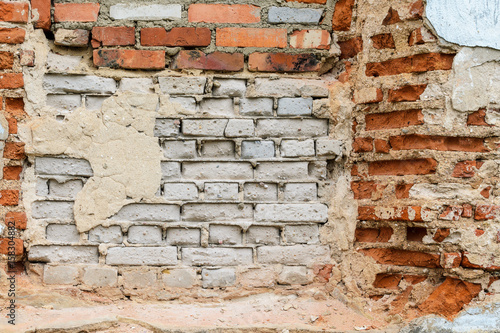 Red brick wall texture shattered by time. Grunge background