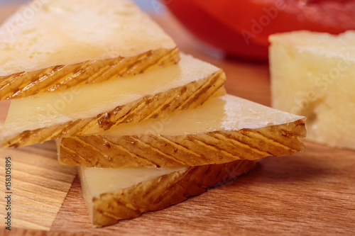 Cheese slices. Typical Spanish tapa of Manchego cheese