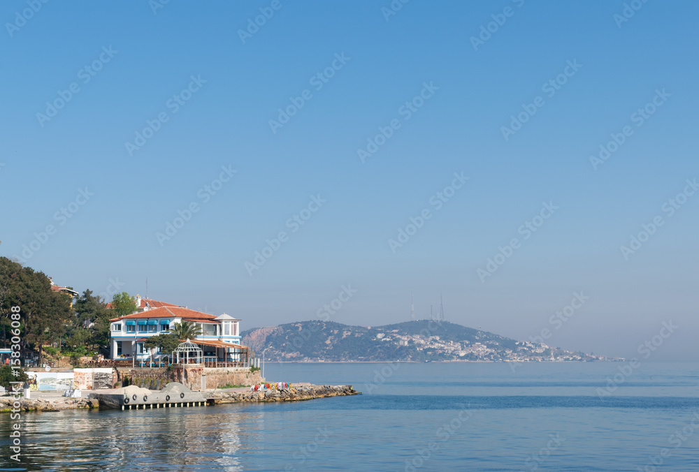 View of Burgazada island from the sea showing a summer house. The island is the third largest one of four islands named Princes' Islands in the Sea of Marmara, near Istanbul, Turkey