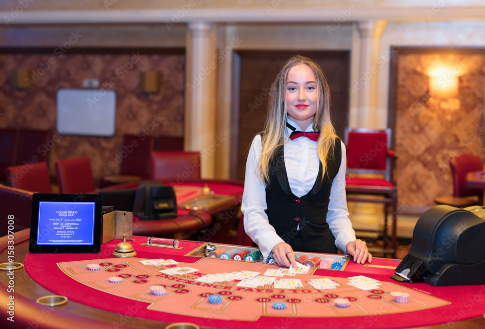 Cute lady casino dealer at Black Jack table. Cute lady casino dealer at Black Jack table.