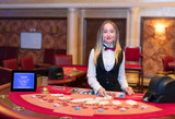 Cute lady casino dealer at Black Jack table.