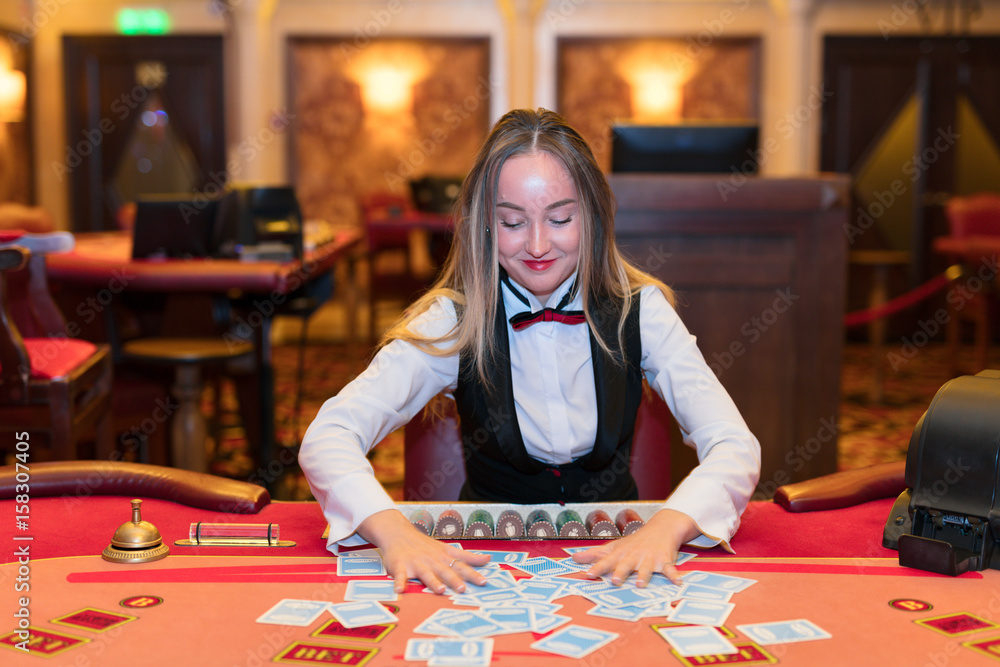 Cute lady casino dealer at poker table. Cute lady casino dealer at poker table.