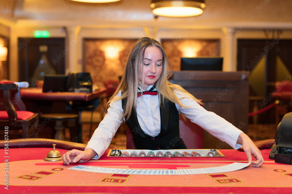 Cute lady casino dealer at poker table. Cute lady casino dealer at poker table.
