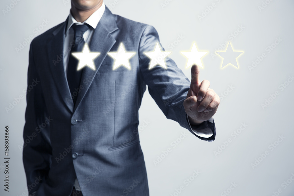 Businessman is give star rating, business background, level business service and product. Businessman is give star rating, business background, level business service and product.