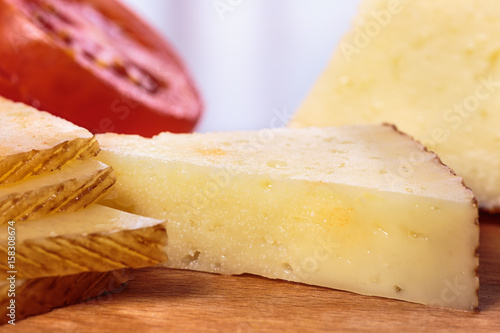 Portions of Manchego curado cheese over a wooden table