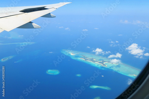 Maldives islands top view and airplane wing