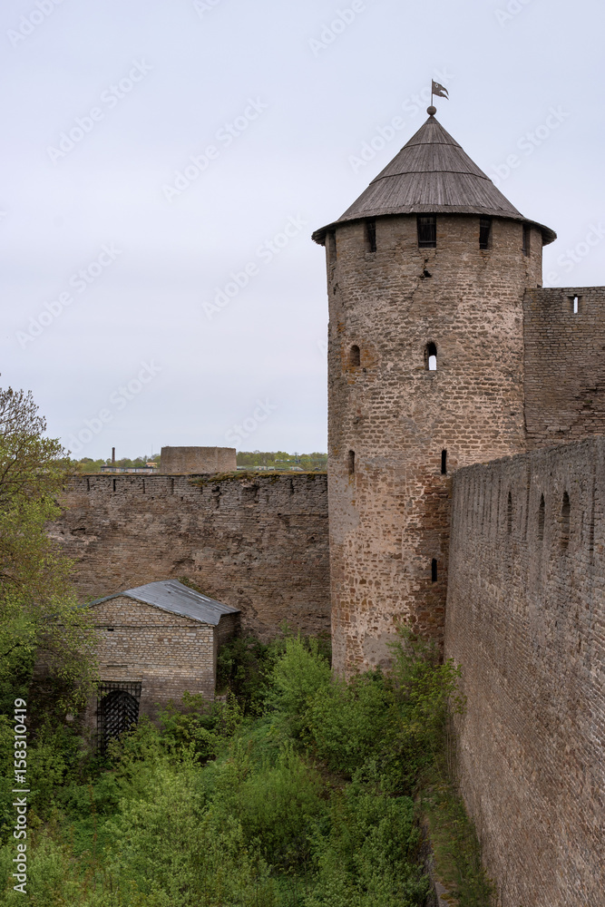 Russian medieval castle in Ivangorod. Located opposite the Estonian city of Narva, not far from St. Petersburg. Watchtower and fortress wall.