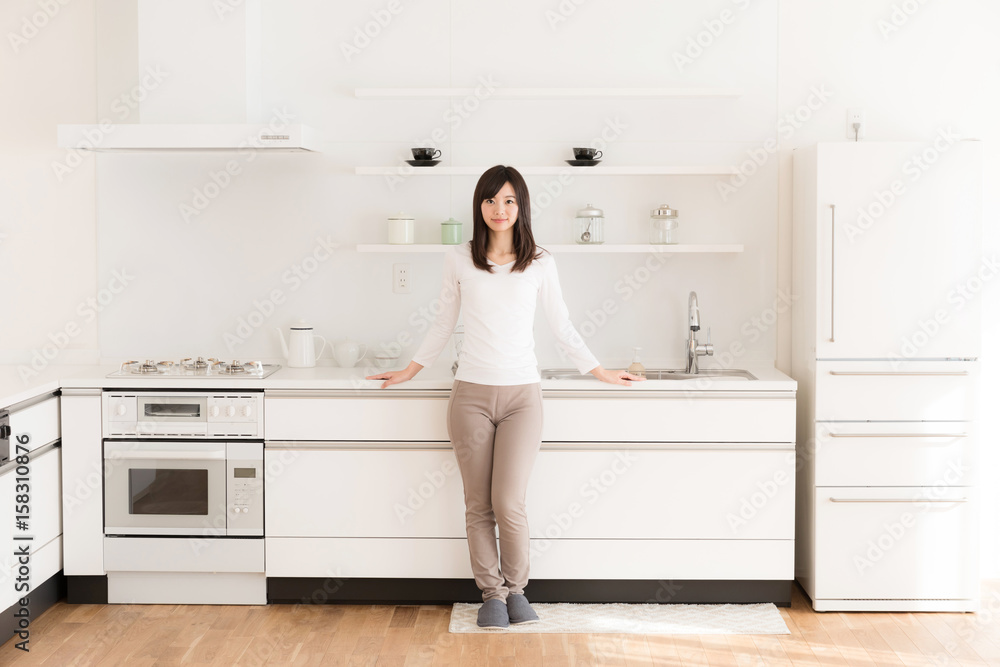 attractive asian woman relaxing in kitchen attractive asian woman relaxing in kitchen