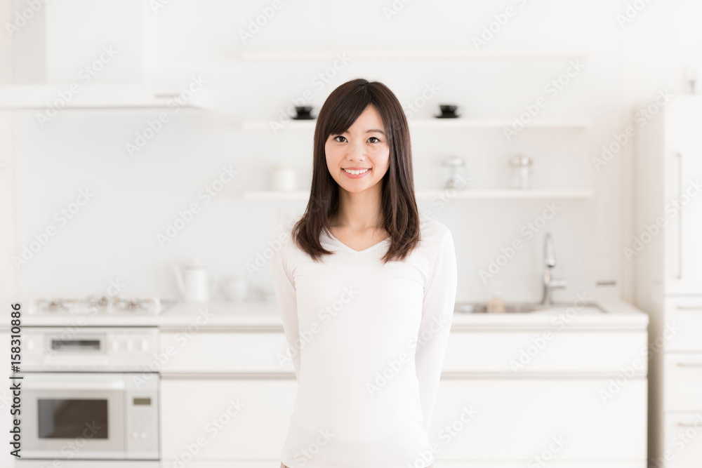 attractive asian woman relaxing in kitchen attractive asian woman relaxing in kitchen