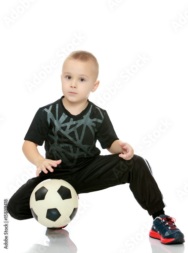 The little boy with the ball in his hands