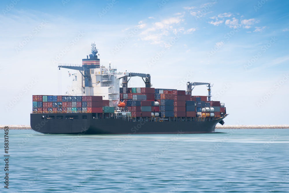 Logistics and transportation of International Container Cargo ship with ports crane bridge in harbor for logistic import export background and transport industry. Logistics and transportation of International Container Cargo ship with ports crane bridge in harbor for logistic import export background and transport industry.