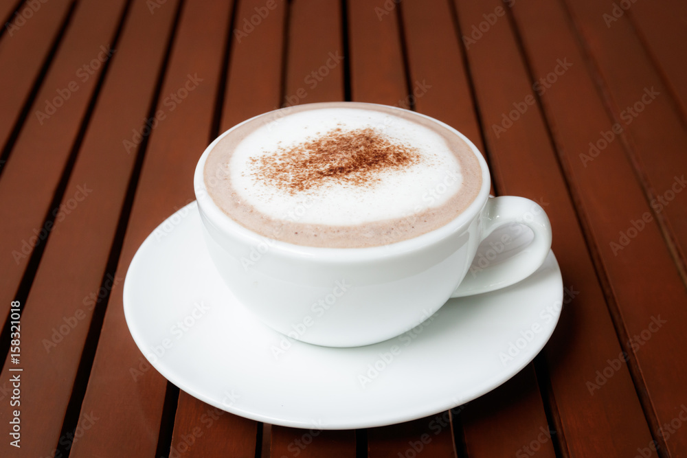 cup of hot chocolate on wooden table background cup of hot chocolate on wooden table background