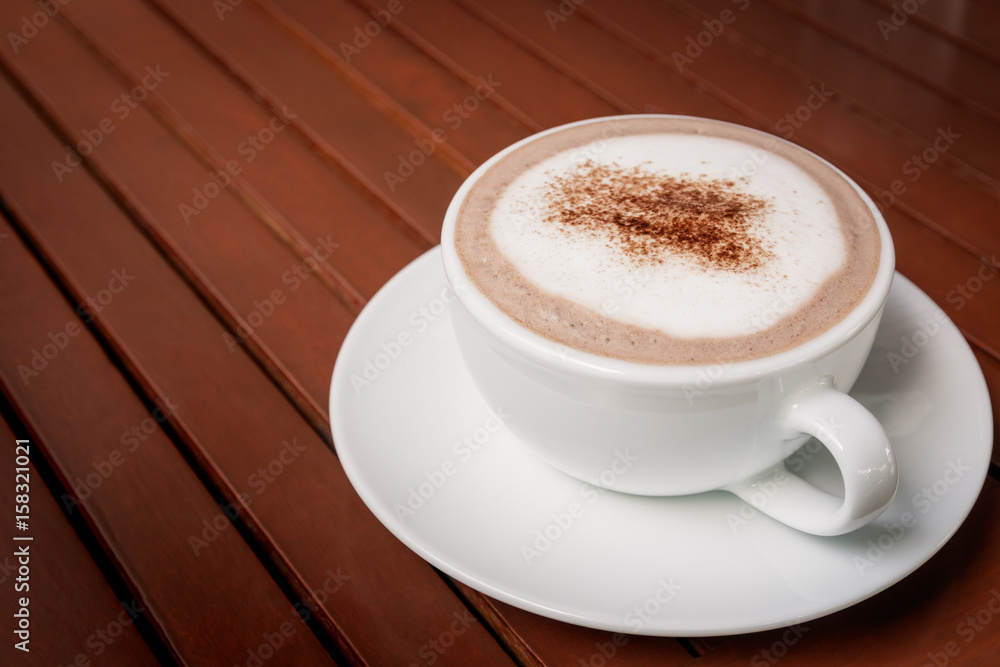 cup of hot chocolate on wooden table background cup of hot chocolate on wooden table background