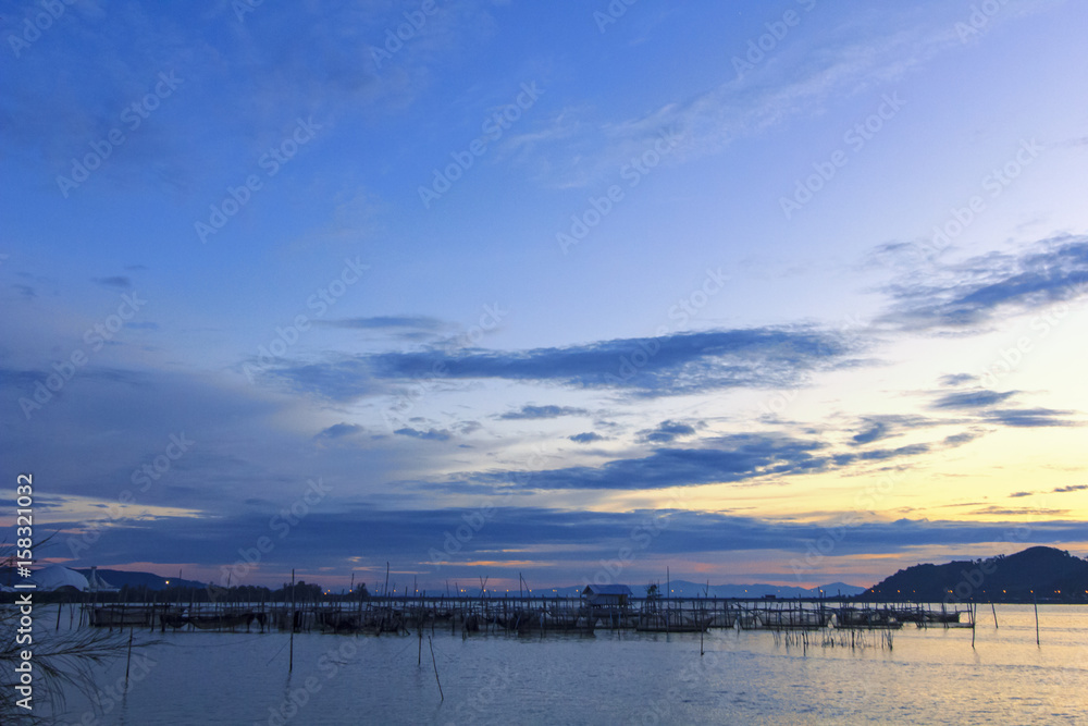 View of Sonkhla lake which has fish cage (sea bass) in water at sunset ; Sonkhla province, Thailand