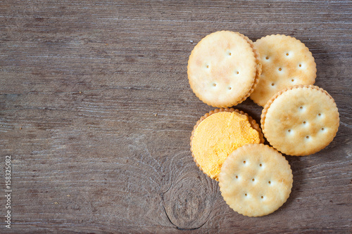 Crackers or biscuit on wooden background, top view
