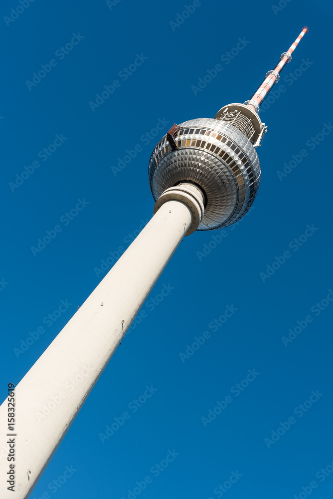 Fototapeta premium The Television Tower in Berlin in front of a blue sky