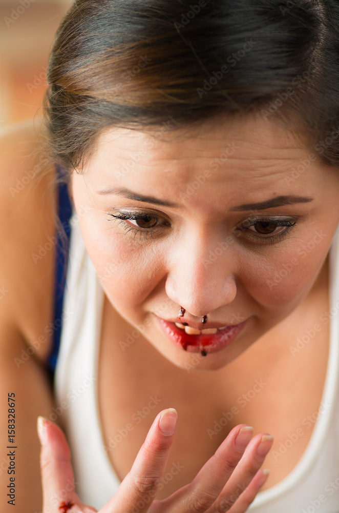 Close up of a beautiful woman nosebleed, woman is bleeding from her nose Close up of a beautiful woman nosebleed, woman is bleeding from her nose