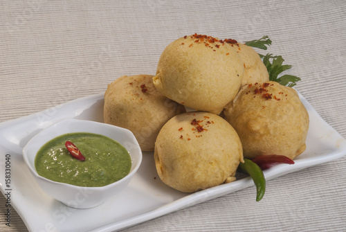 Wallpaper Mural Batata Vada with garlic and mint chutney and chilli on white plate   Torontodigital.ca