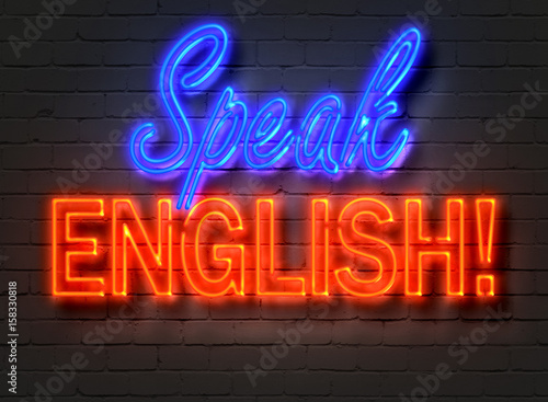 Speak English  neon sign on brick wall