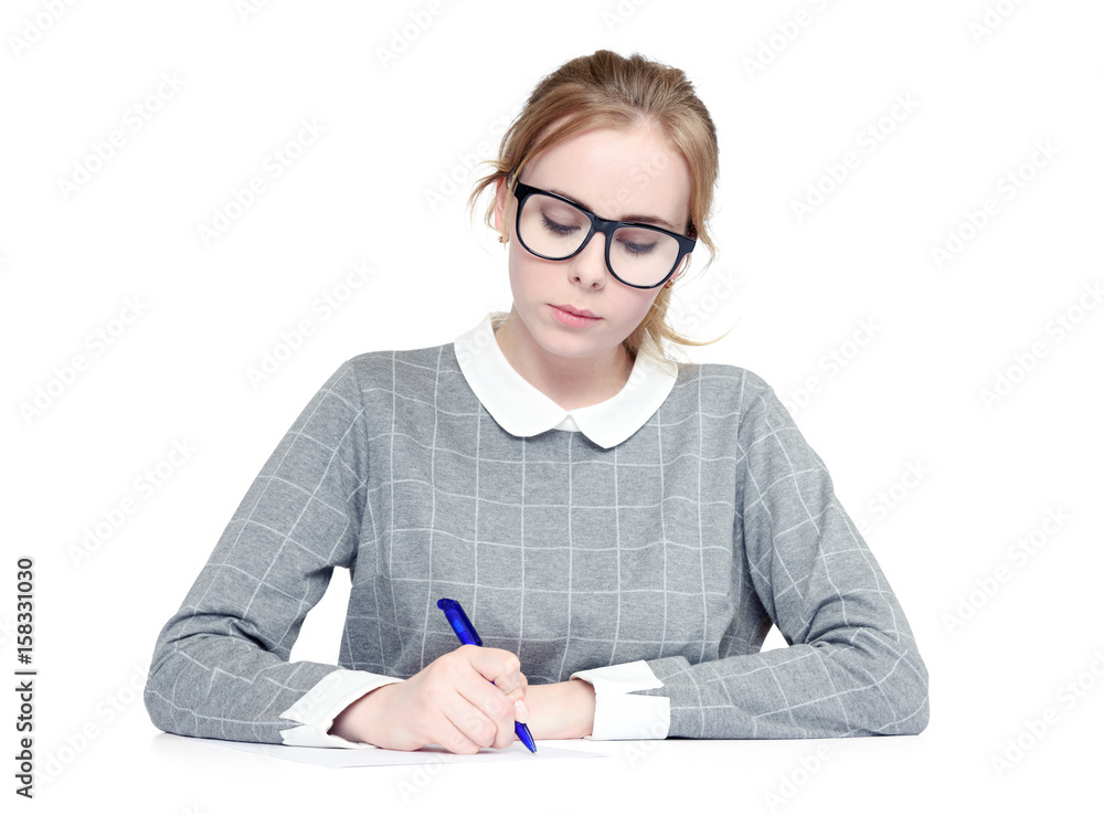 Young woman with glasses writes pen on paper, on white background