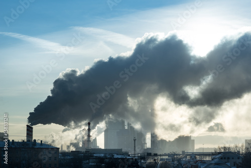 skyscrapers of the Moscow city were shot during the cold day in the smoke from the pipe.