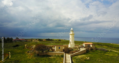 Ancient lighthouse near Mediterranean Sea . Summer landscape. Cyprus.City resort.	