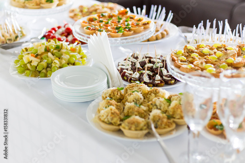A small table with a delicious buffet of canapes, caviar, sandwiches