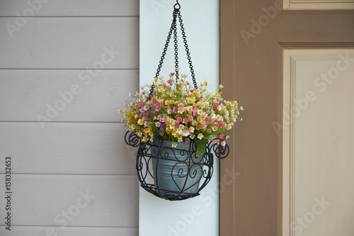 Flower basket hanging on the wall, home decoration.