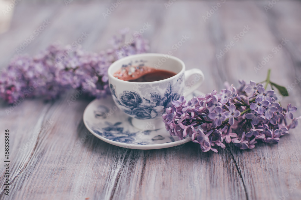 Creative layout is made with lilac with cup of coffee..Nature concept. Creative layout is made with lilac with cup of coffee..Nature concept.