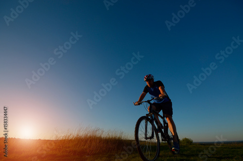 Male cyclist driving outdoors © Mikhailov Studio