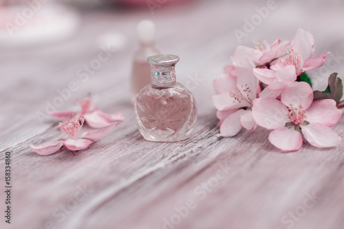 Creative layout perfume and petals of a blossoming apple tree.. Beauty concept