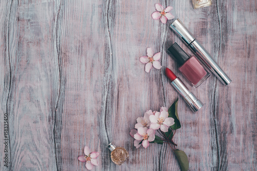 Creative layout cosmetics, perfume and petals of a blossoming apple tree. Beauty concept. Flat lay. photo