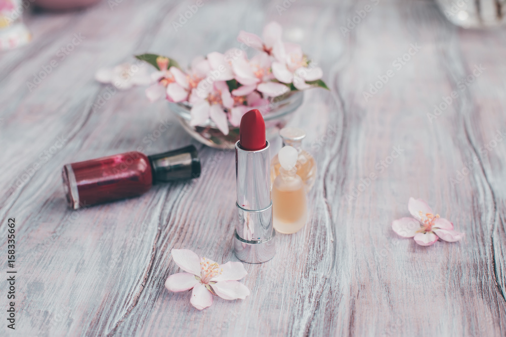 Creative layout cosmetics, perfume and petals of a blossoming apple tree Beauty concept Creative layout cosmetics, perfume and petals of a blossoming apple tree Beauty concept