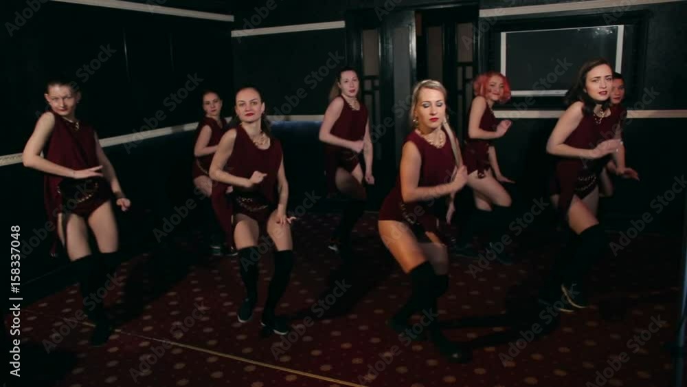 Eight beautiful and sexy girls dance twerking at a nightclub. Group of hot girls dancing twerk