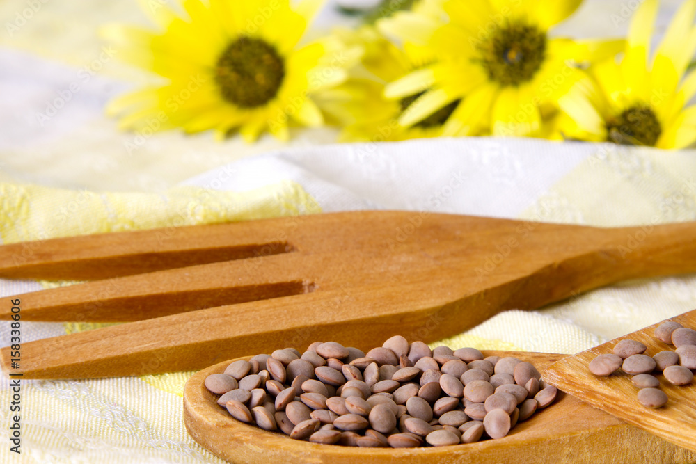 Wooden cutlery and daisies with lentils Wooden cutlery and daisies with lentils