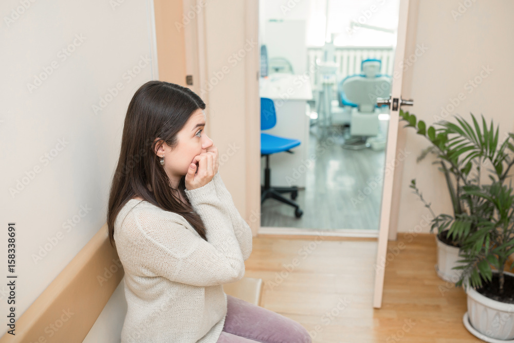 Three patients sitting in doctor's waiting room Three patients sitting in doctor's waiting room