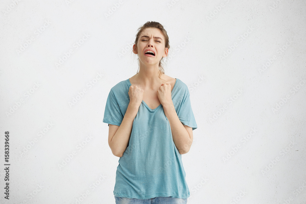 Unhappy teenage girl crying heart out, feeling desperate after parents didn't take her on vacations with them. Stressed whining young woman burst into sobbing because of intolerable toothache Unhappy teenage girl crying heart out, feeling desperate after parents didn't take her on vacations with them. Stressed whining young woman burst into sobbing because of intolerable toothache