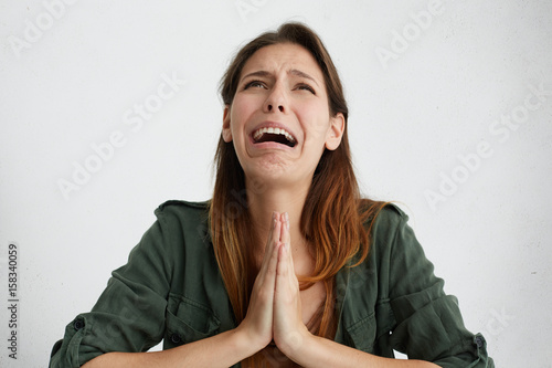 Φωτογραφία Portrait of desperate woman begging for mercy and crying