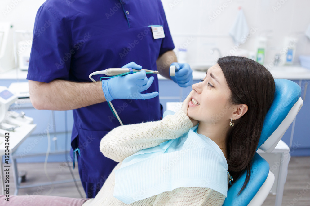 Unhappy patient having a toothache in dental clinic Unhappy patient having a toothache in dental clinic