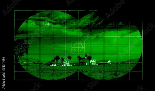 Houses in countryside through night vision