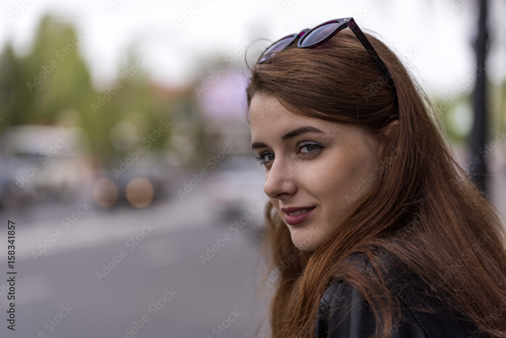 Girl with long hair posing on city street Girl with long hair posing on city street