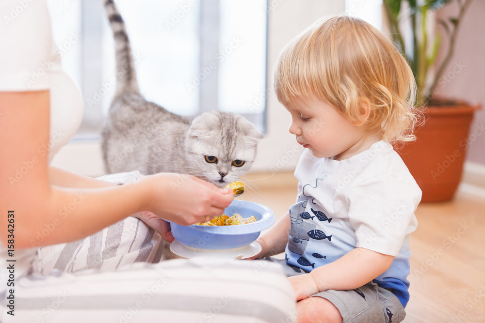Mother with her child eating together and have a fun Mother with her child eating together and have a fun