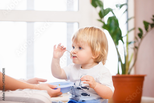 Mother with her child eating together and have a fun