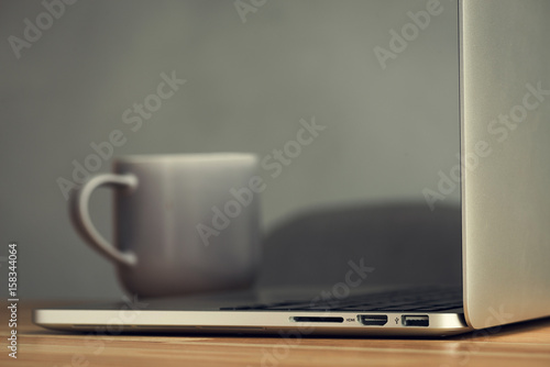 coffee cup and laptop in office table