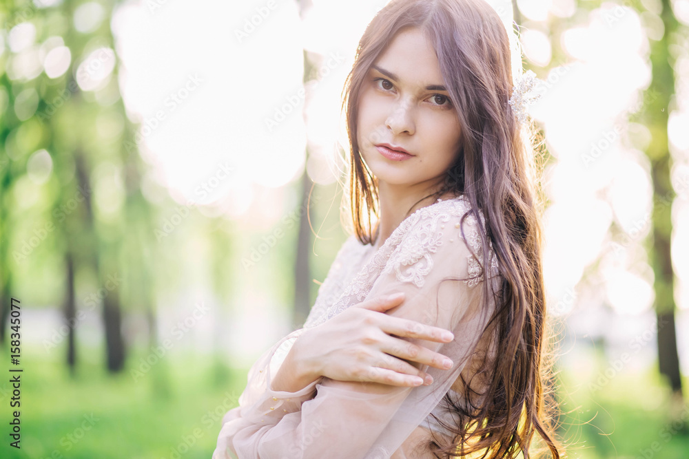 beautiful girl in wedding dress beige with patterns, lace, smiling, looking at nature beautiful girl in wedding dress beige with patterns, lace, smiling, looking at nature