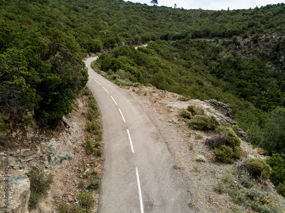 Aerial view of small curvy road in Corsica Aerial view of small curvy road in Corsica