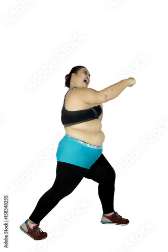 Fat woman with punching style © Creativa Images