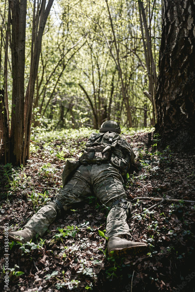 Soldier lies in ambush at forest