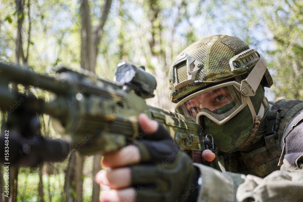 Soldier in helmet takes aim Soldier in helmet takes aim